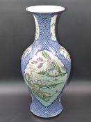 A CHINESE BLUE AND WHITE BALUSTER FORM VASE WITH FAMILLE ROSE CARTOUCHE PANELS OF FIGURES, FLOWERS