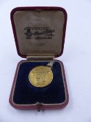 A CASED 18ct STAMPED REVERSE BOWDON GOLF CLUB MEDALLION WITH THE SLOGAN GOLD IS NOT AGRICULTURE