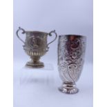 A VICTORIAN SILVER HALLMARKED TROPHY CUP, WITH CHASED FLORAL DECORATION AND ENGRAVING DATED 1889,