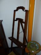 A CARVED OAK DISPLAY EASEL.