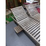 A PAIR OF TEAK GARDEN LOUNGERS.