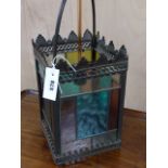 AN ANTIQUE BRASS FRAMED HALL LANTERN WITH LEADED STAINED GLASS PANELS. H.64cms.