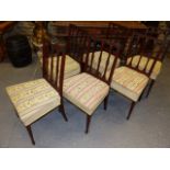 A SET OF SIX LATE GEORGIAN MAHOGANY DINING CHAIRS ON SQUARE TAPERED LEGS WITH SPADE FEET.