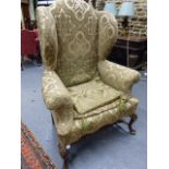 A PAIR OF GEO.I.STYLE LARGE WING BACK ARMCHAIRS ON CARVED CABRIOLE LEGS.