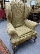 A PAIR OF GEO.I.STYLE LARGE WING BACK ARMCHAIRS ON CARVED CABRIOLE LEGS.