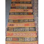 A FLAT WOVEN TURKOMAN TRIBAL BAG AND A FLAT WOVEN PANEL WITH BROCADED DESIGNS. 210 x 77cms. (2)
