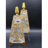 A PAIR OF MOSER STYLE TRIANGULAR SHAPED EAU DE COLOGNE GLASS JARS DECORATED WITH ENAMEL SCENES OF