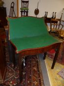 AN 18th.C.MAHOGANY FOLD OVER CARD TABLE OF SERPENTINE OUTLINE ON FLUTED SQUARE SECTION LEGS. W.86