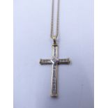 A 9ct YELLOW GOLD DIAMOND SET CROSS, 4cms X 2cms, ESTIMATED DIAMOND WEIGHT 0.50cts, SUSPENDED ON A