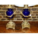 A PAIR OF ANTIQUE FRENCH ORMOLU MOUNTED VASES ADAPTED TO TABLE LAMPS WITH RAM'S HEAD HANDLES AND