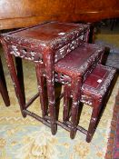 A CHINESE CARVED HARDWOOD NEST OF THREE TABLES, THE LARGEST H.50cms.