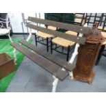 AN ANTIQUE SMALL GARDEN BENCH WITH BRANCH FORM CAST IRON ENDS. W.119cms.