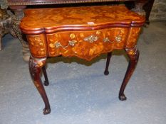 A GEORGIAN MAHOGANY AND MARQUETRY INLAID FOLD OVER GAMING TABLE ON CABRIOLE LEGS AND CLAW AND BALL