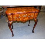 A GEORGIAN MAHOGANY AND MARQUETRY INLAID FOLD OVER GAMING TABLE ON CABRIOLE LEGS AND CLAW AND BALL