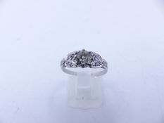 AN 18ct STAMPED OLD CUT DIAMOND RING. THE CENTRAL OLD CUT DIAMOND IS HELD IN AN EIGHT CLAW SETTING