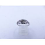 AN 18ct STAMPED OLD CUT DIAMOND RING. THE CENTRAL OLD CUT DIAMOND IS HELD IN AN EIGHT CLAW SETTING