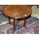 A SMALL WALNUT CIRCULAR LOW TABLE IN THE MANNER OF PETER WAALS.
