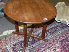 A SMALL WALNUT CIRCULAR LOW TABLE IN THE MANNER OF PETER WAALS.