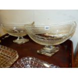 AN IRISH NAVETTE CUT GLASS SHAPED PEDESTAL DISH. L.30cms. H.21cms A SIMILAR SMALLER DISH, L.25cms.