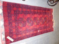 AN AFGHAN BOKHARA RUG. 218 x 107cms.