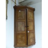 A GOOD QUALITY COTSWOLD SCHOOL ARTS AND CRAFTS WALNUT TWO DOOR CORNER CABINET.