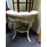 AN ANTIQUE CAST IRON GARDEN TABLE WITH MARBLE TOP. Dia.68 x H.76cms.