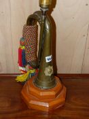 A VINTAGE REGIMENTAL BUGLE LATER MOUNTED AS A LAMP.