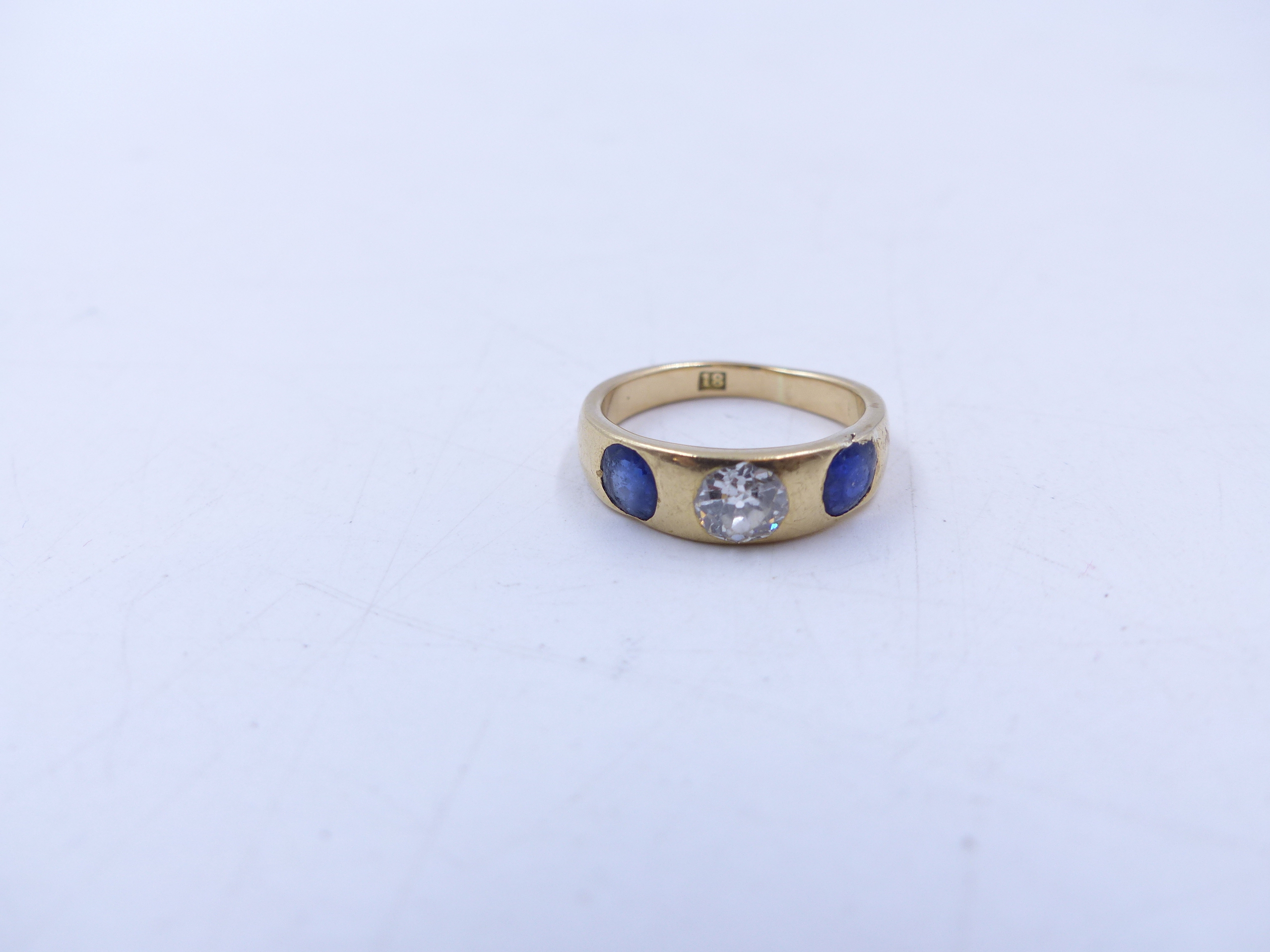 AN 18 STAMPED YELLOW GOLD SAPPHIRE AND DIAMOND THREE STONE TRADITIONAL GYPSY-SET RING. THE CENTRE - Image 8 of 9