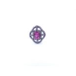 A PINK TOURMALINE AND DIAMOND OPEN WORK FILIGREE RING SET IN A WHITE METAL MOUNT,THE CENTRAL PINK