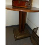 A CONTINENTAL ARTS AND CRAFTS STYLE CIRCULAR CENTRE TABLE ON CLUSTER COLUMN SUPPORTS AND STUDDED