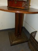 A CONTINENTAL ARTS AND CRAFTS STYLE CIRCULAR CENTRE TABLE ON CLUSTER COLUMN SUPPORTS AND STUDDED