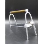 AN INTERESTING ART DECO FRENCH CHROME WINE BOTTLE CRADLE.