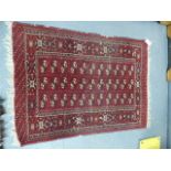 A PERSIAN BOKHARA RUG. 126 x 95cms TOGETHER WITH A SMALLER BELOUCH RUG. (2)