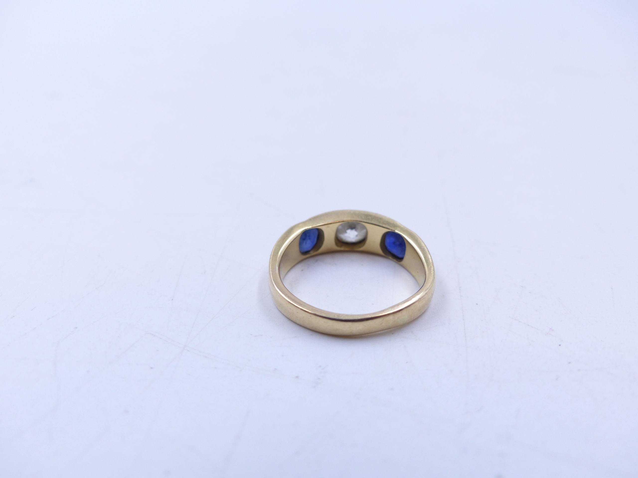 AN 18 STAMPED YELLOW GOLD SAPPHIRE AND DIAMOND THREE STONE TRADITIONAL GYPSY-SET RING. THE CENTRE - Image 9 of 9