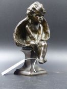 A SMALL ANTIQUE BRONZE FIGURE OF A SEATED WINGED CHERUB, UNSIGNED BUT ATTRIBUTED BY REPUTE TO