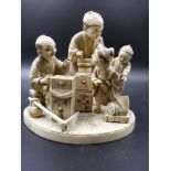 A JAPANESE CARVED IVORY GROUP OF TRADESMEN AND CHILDREN ON A SHAPED BASE WITH INSET SIGNATURE