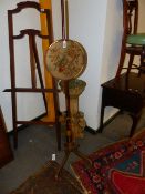 A REGENCY PAINT DECORATED POLE SCREEN WITH NEEDLEPOINT PANEL.