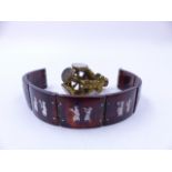 A VINTAGE TORTOISE SHELL AND WHITE METAL INLAID SIAM ART PANEL BRACELET TOGETHER WITH A ROTATING WAX