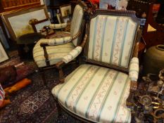 A PAIR OF FRENCH EBONISED AND GILT DECORATED OPEN ARMCHAIRS.