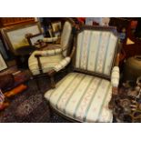 A PAIR OF FRENCH EBONISED AND GILT DECORATED OPEN ARMCHAIRS.