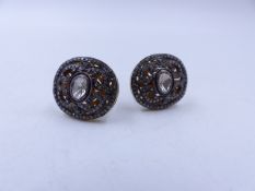 A PAIR OF ORNATE FILIGREE GENTS DIAMOND CUFFLINKS SET IN SILVER WITH GILDED BACKS. HEAD