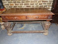 A LARGE 19th.C.CARVED OAK CENTRE TABLE, TWO DRAWERS WITH CARVED MASK HANDLES AND OPPOSING DUMMY