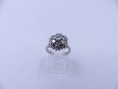 AN 18ct HALLMARKED WHITE GOLD DIAMOND DOUBLE CLUSTER RING. THE BRILLIANT CUT DIAMONDS ARE CLAW