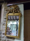 AN ANTIQUE CARVED GILTWOOD PIER MIRROR WITH FLORAL SWAG CREST.