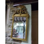 AN ANTIQUE CARVED GILTWOOD PIER MIRROR WITH FLORAL SWAG CREST.