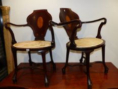 AN UNUSUAL PAIR OF MAHOGANY ARMCHAIRS WITH INLAID PANEL BACKS.