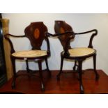 AN UNUSUAL PAIR OF MAHOGANY ARMCHAIRS WITH INLAID PANEL BACKS.