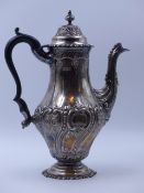 A VICTORIAN SILVER HALLMARKED COFFEE POT OF BALUSTER FORM CHASED WITH A FLORAL DECORATION DATED