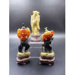 A PAIR OF CARVED FIGURAL HARDSTONE SNUFF BOTTLES ON PIERCED HARDWOOD BASES OVERALL H.10.5cms AND A