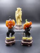 A PAIR OF CARVED FIGURAL HARDSTONE SNUFF BOTTLES ON PIERCED HARDWOOD BASES OVERALL H.10.5cms AND A